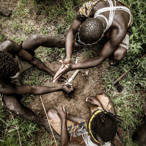 Men of the Hadzabe tribe use tools found in nature to start a fire