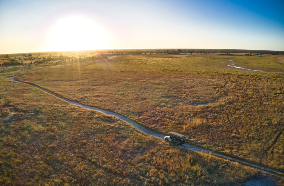 An aerial view of a vehicle driving through the plains